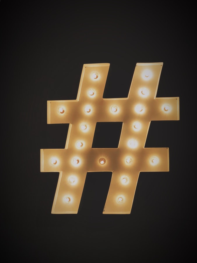 hashtag sign with light bulbs lit up